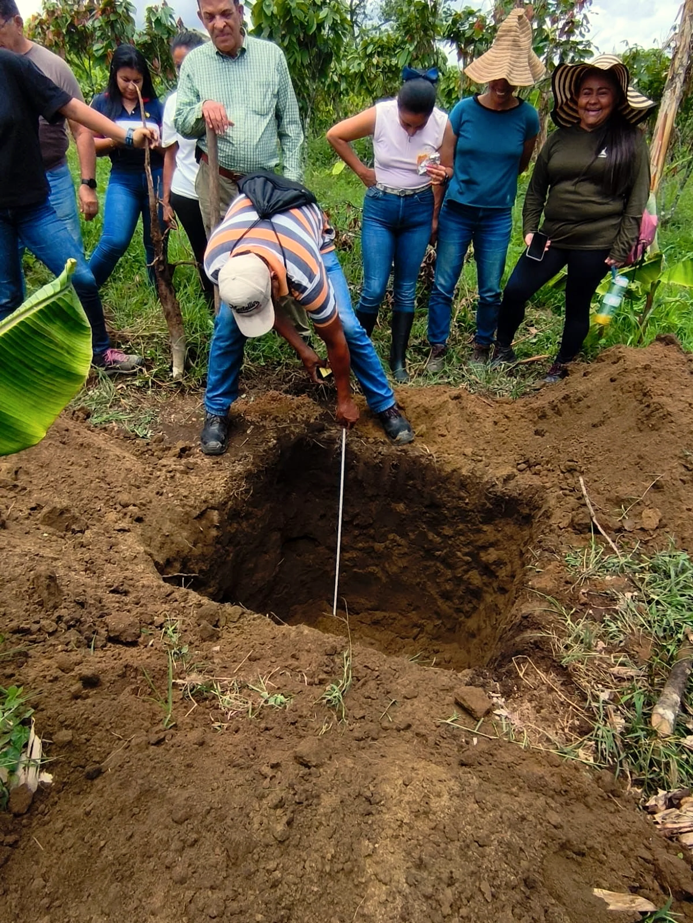 The Flórez family at the soil pit on Finca La Tesalia — five generations have stewarded this land.